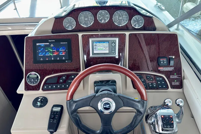 Slide: The Image of Cockpit of 2008 Sea Ray Sundancer 330 with advanced navigation controls and steering wheel. - 11