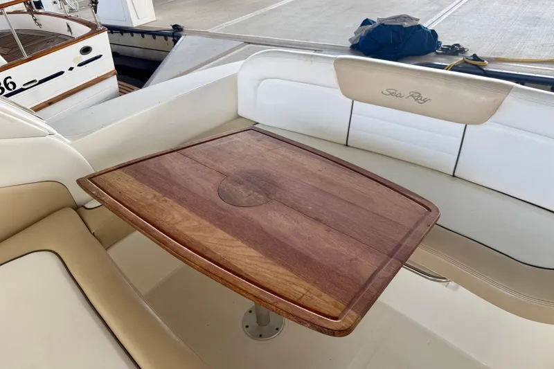 Slide: The Image of 2008 Sea Ray Sundancer 330 interior with wooden table and cushioned seating. - 8