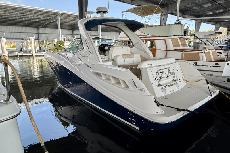 Slide: The Image of 2008 Sea Ray Sundancer 330 docked in a marina, showcasing sleek design and luxury features. - 3
