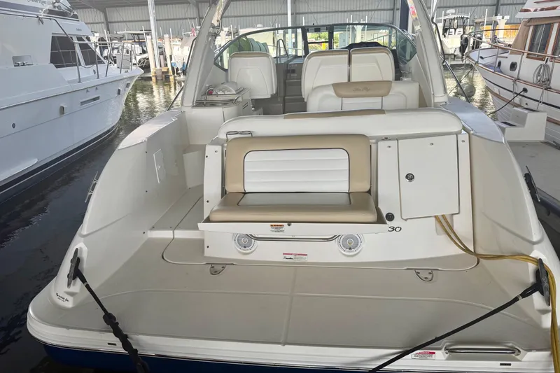 Slide: The Image of 2008 Sea Ray Sundancer 330 yacht docked in marina, showcasing spacious seating and sleek design. - 5