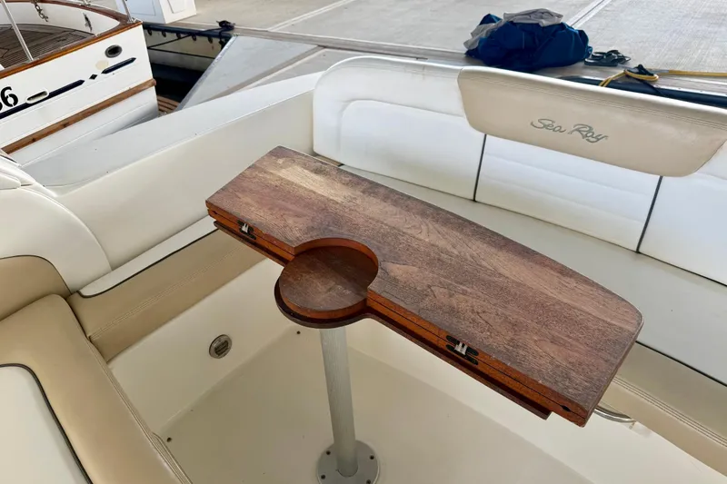 Slide: The Image of 2008 Sea Ray Sundancer 330 interior with wooden table and cushioned seating. - 9