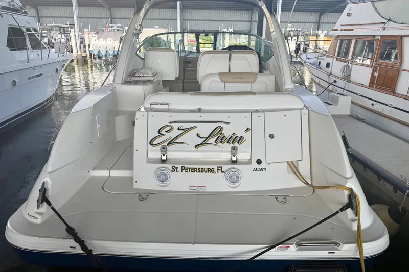Slide: The Image of 2008 Sea Ray Sundancer 330 docked in marina, rear view with "EZ Livin'" nameplate. - 4