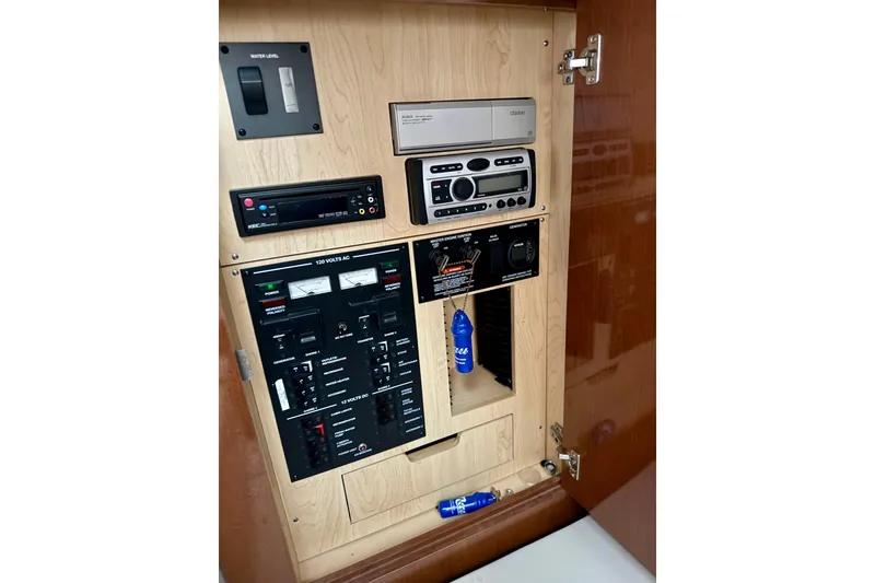 Slide: The Image of Electrical control panel inside 2008 Sea Ray Sundancer 330 boat, featuring various switches and meters. - 18