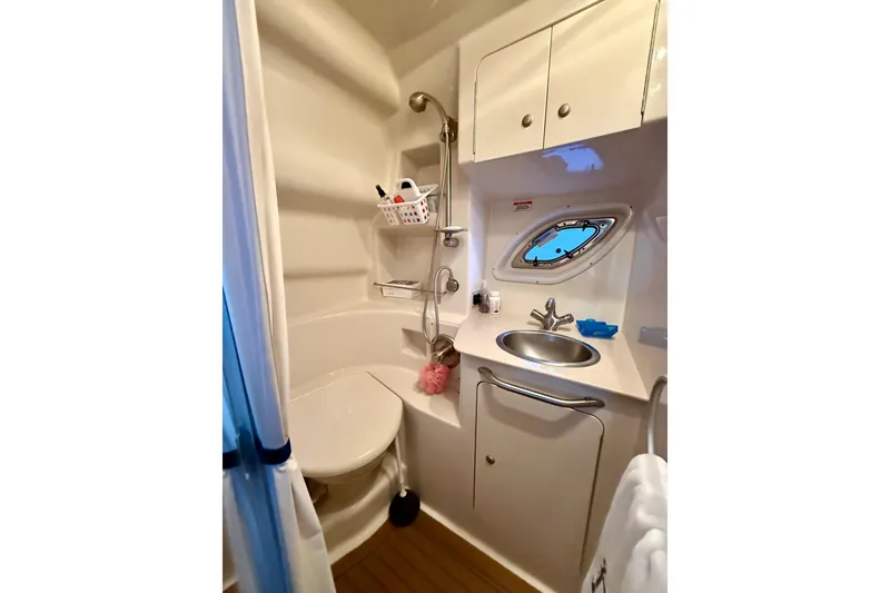 Slide: The Image of 2008 Sea Ray Sundancer 330 bathroom with shower, sink, and porthole window. - 17