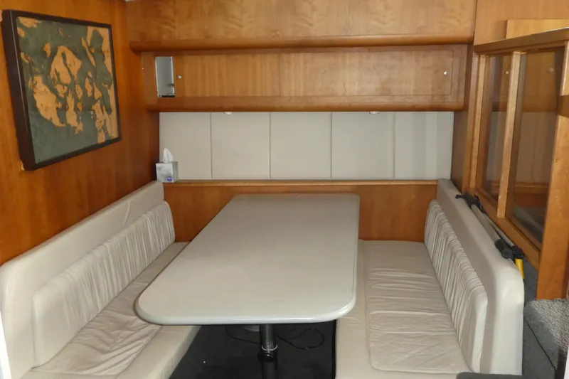 Slide: The Image of 1997 Silverton 41 Convertible interior with cozy dining area and wooden cabinetry. - 9
