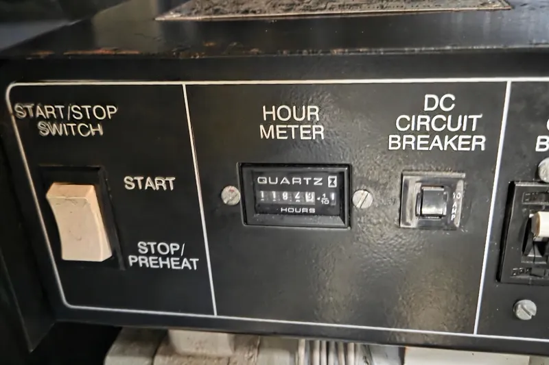 Slide: The Image of Control panel of a 1997 Silverton 41 Convertible boat with hour meter and switches. - 25