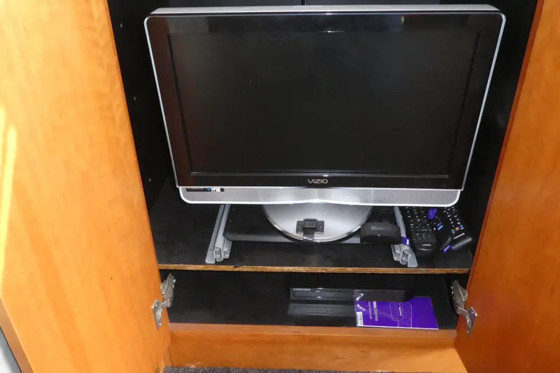 Slide: The Image of Vizio TV and electronics in a cabinet on a 1997 Silverton 41 Convertible boat. - 22