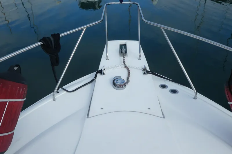 Slide: The Image of Bow view of 1997 Silverton 41 Convertible yacht with anchor chain and railing. - 33