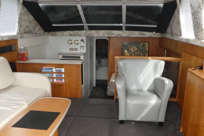 Slide: The Image of Interior of a 1997 Silverton 41 Convertible yacht with modern furnishings and ample seating. - 3