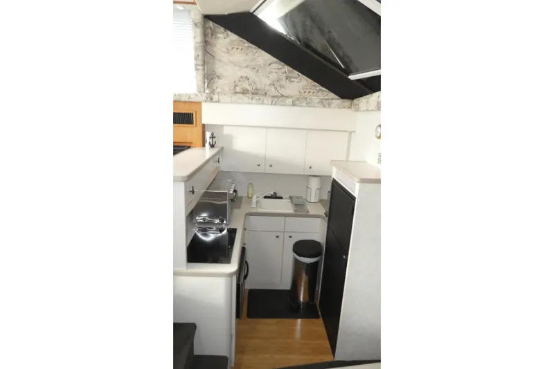 Slide: The Image of Interior view of 1997 Silverton 41 Convertible yacht kitchen with modern appliances. - 7
