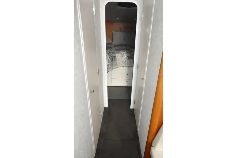 Slide: The Image of Interior hallway of a 1997 Silverton 41 Convertible yacht, leading to a cozy bedroom. - 10
