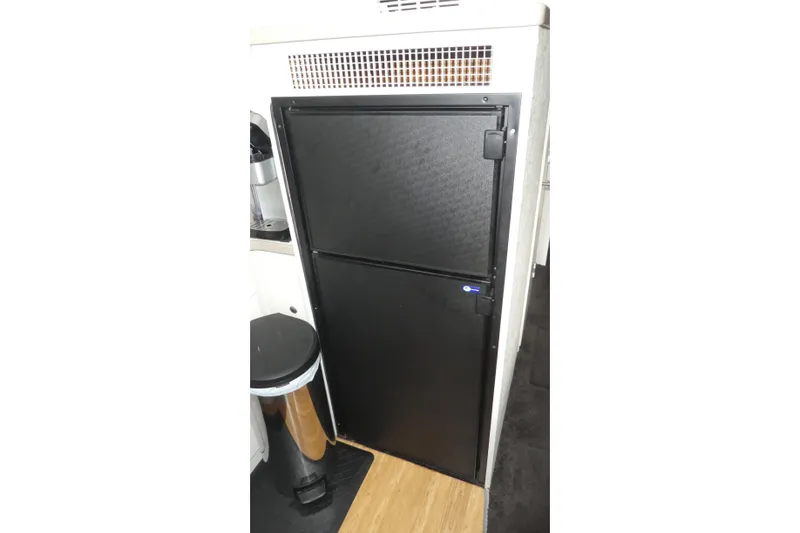 Slide: The Image of Black refrigerator inside 1997 Silverton 41 Convertible yacht kitchen area. - 8
