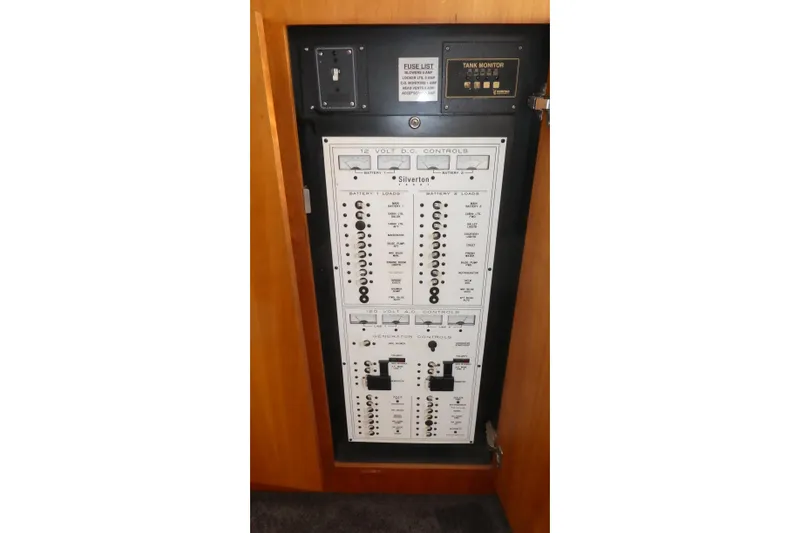 Slide: The Image of Electrical control panel of a 1997 Silverton 41 Convertible boat, featuring DC and AC controls. - 19