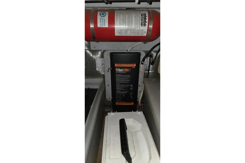 Slide: The Image of Engine compartment of a 1997 Silverton 41 Convertible with fire extinguisher and ProTech battery charger. - 31