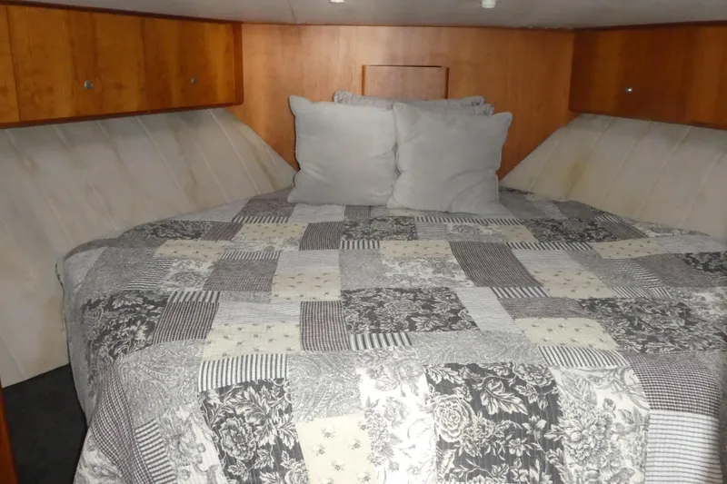Slide: The Image of Cozy cabin bedroom in 1997 Silverton 41 Convertible yacht with patchwork quilt. - 11
