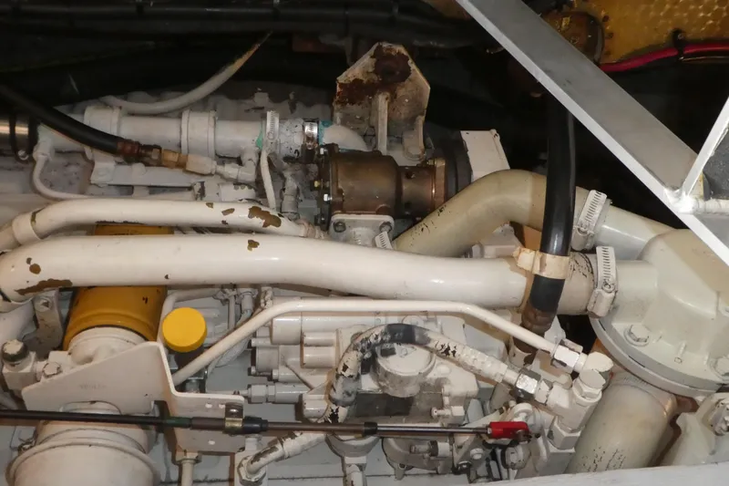 Slide: The Image of Engine compartment of a 1997 Silverton 41 Convertible boat, showing pipes and mechanical components. - 29