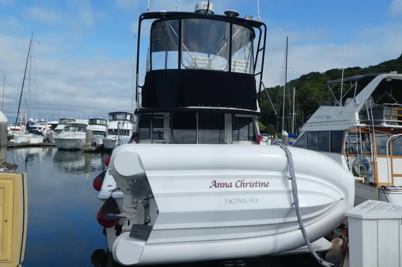 Slide: The Image of 1997 Silverton 41 Convertible boat named "Anna Christine" docked in a marina. - 45