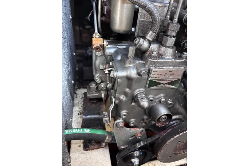 Slide: The Image of Engine close-up of a 1984 Islander 28 sailboat, showcasing mechanical components. - 18