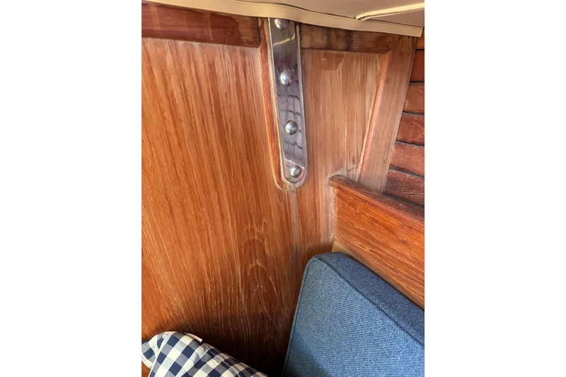 Slide: The Image of Interior of 1984 Islander 28 sailboat with wooden paneling and blue cushion. - 19