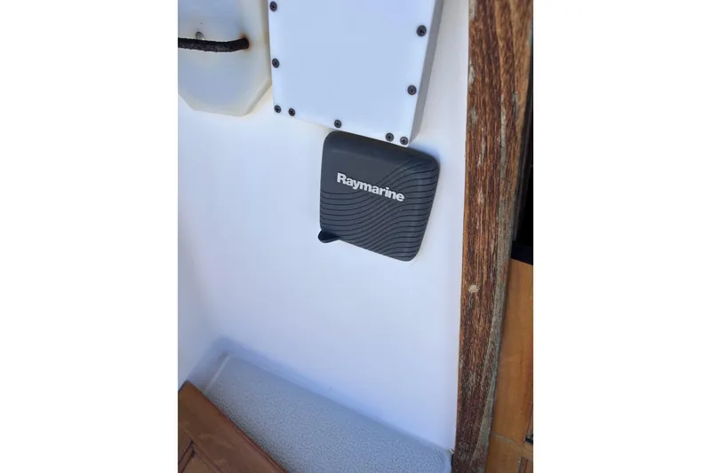 Slide: The Image of Raymarine device on 1984 Islander 28 sailboat interior, featuring wood and white paneling. - 28