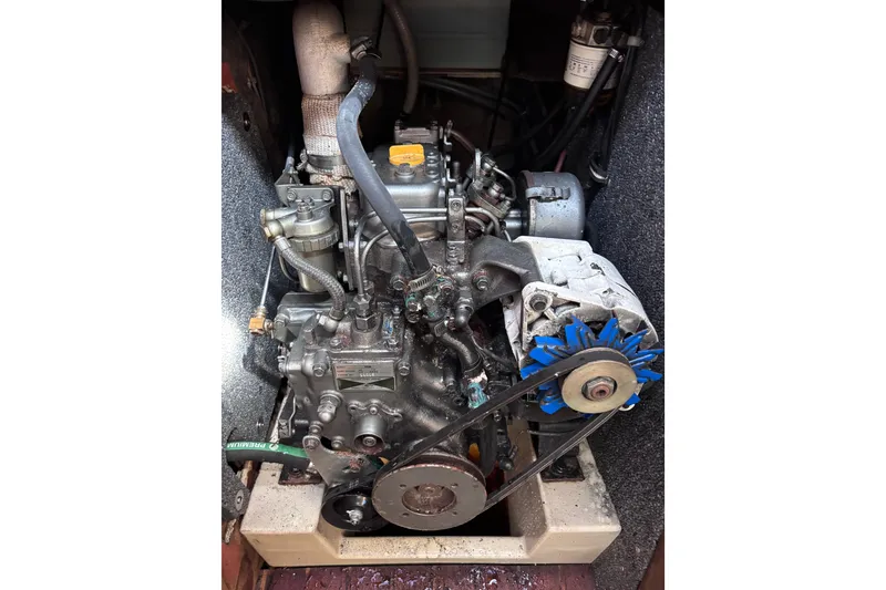 Slide: The Image of Engine of a 1984 Islander 28 sailboat, showcasing mechanical components and belts. - 15