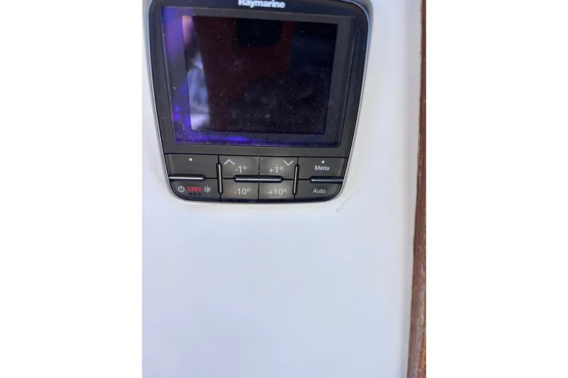 Slide: The Image of Raymarine control panel on 1984 Islander 28 sailboat, featuring navigation buttons and display. - 29