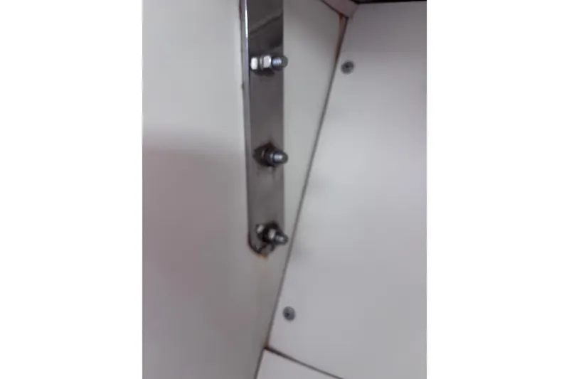 Slide: The Image of Close-up of metal bolts on 1984 Islander 28 boat interior. - 20