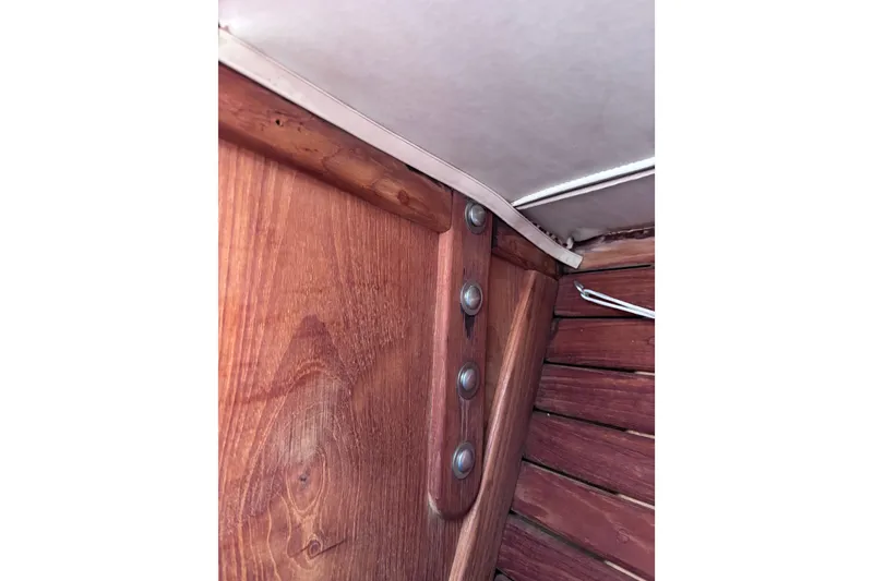 Slide: The Image of Interior woodwork detail of a 1984 Islander 28 sailboat, showcasing craftsmanship and design. - 21