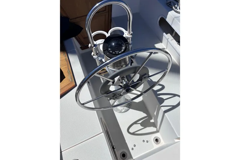 Slide: The Image of Steering wheel and compass of a 1984 Islander 28 sailboat cockpit. - 26
