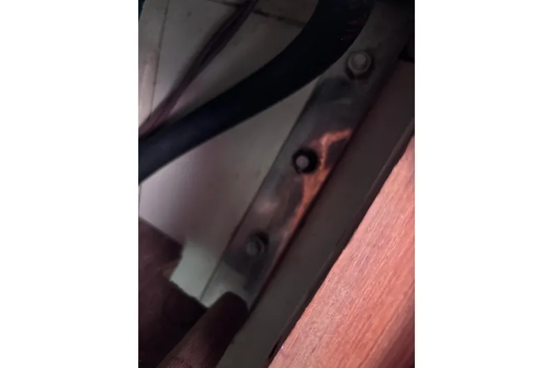 Slide: The Image of Interior detail of a 1984 Islander 28 sailboat, featuring metal and wood components. - 22