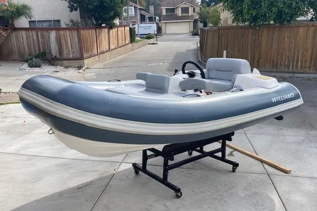 The Image of 2019 Williams Jet Tenders 285 Turbo Jet boat on display in a residential driveway. - 1