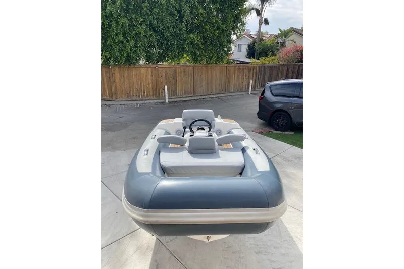 Slide: The Image of 2019 Williams Jet Tenders 285 Turbo Jet boat parked in a driveway. - 2