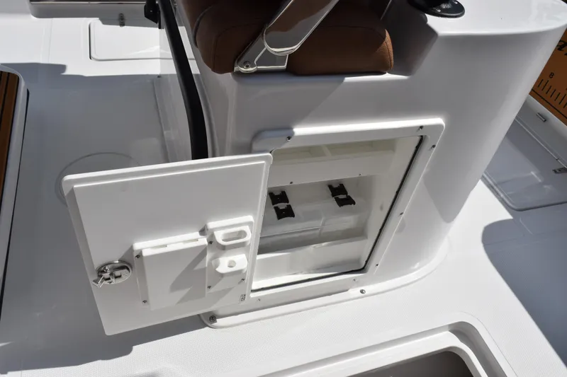 Slide: The Image of Open storage compartment on 2026 Sea Hunt Gamefish 25 boat, featuring sleek white design. - 18
