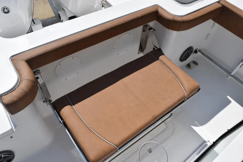 Slide: The Image of 2026 Sea Hunt Gamefish 25 boat with brown cushioned seating and sleek design. - 21