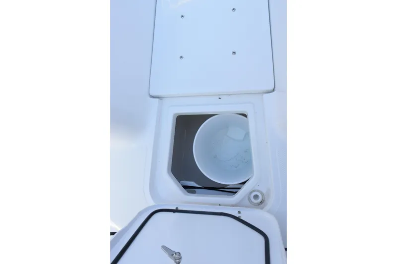 Slide: The Image of Storage compartment on 2026 Sea Hunt Gamefish 25 boat, featuring a white bucket inside. - 15