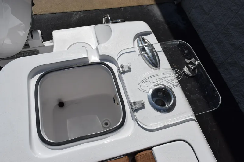 Slide: The Image of Sea Hunt Gamefish 25 (2026) boat's livewell and bait station with clear lid. - 20