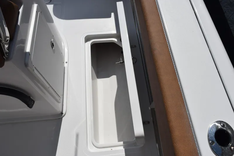 Slide: The Image of 2026 Sea Hunt Gamefish 25 boat interior storage compartment, open and empty. - 17