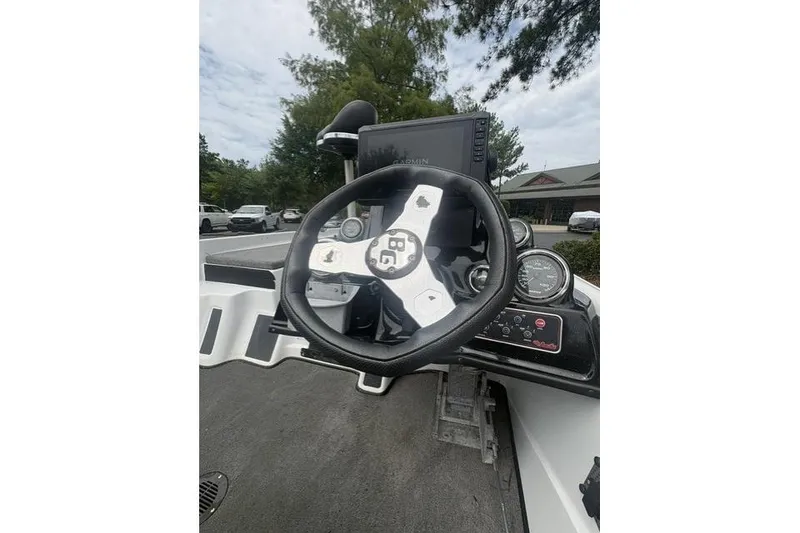 Slide: The Image of 2012 Bass Cat Cougar FTD boat dashboard with steering wheel and gauges. - 17