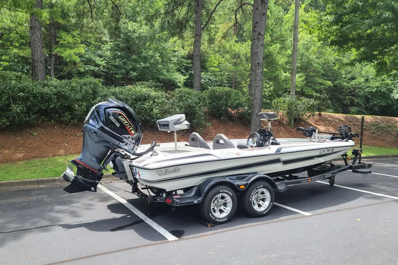 Slide: The Image of 2012 Bass Cat Cougar FTD boat with Yamaha engine in a parking lot. - 7