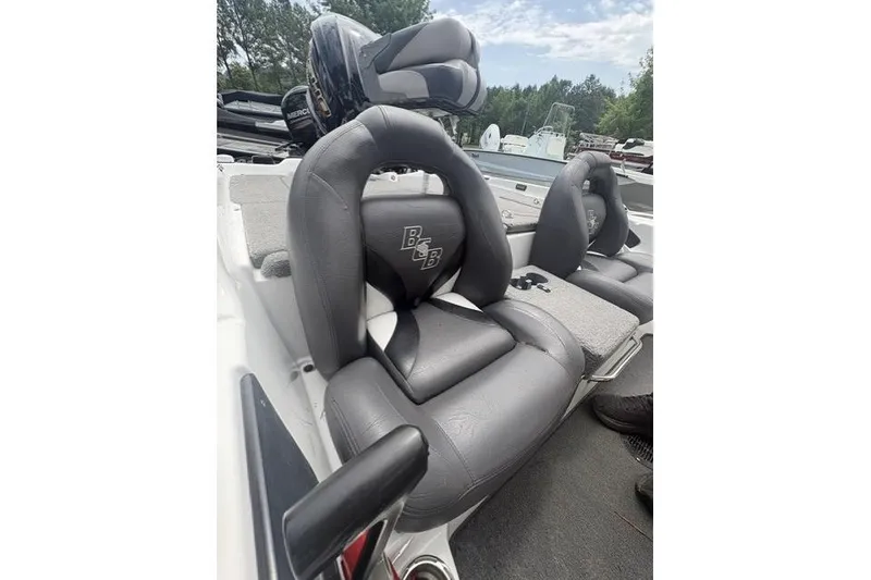 Slide: The Image of 2012 Bass Cat Cougar FTD boat seats, gray leather, outdoor setting. - 13