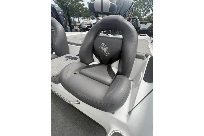 Slide: The Image of 2012 Bass Cat Cougar FTD boat seat, gray leather, with logo, on deck. - 12