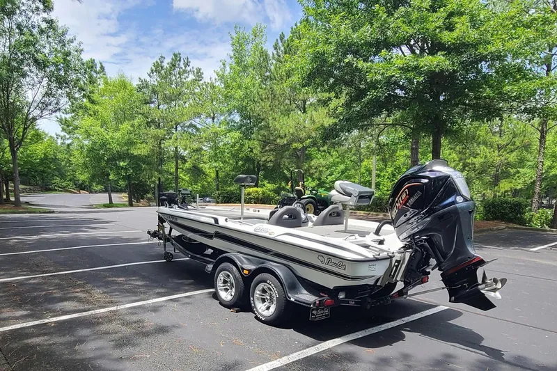 Slide: The Image of 2012 Bass Cat Cougar FTD boat on trailer in a sunny parking lot. - 3