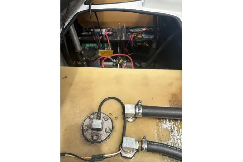 Slide: The Image of 2012 Bass Cat Cougar FTD boat battery compartment with wiring and connections. - 18