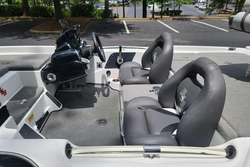 Slide: The Image of 2012 Bass Cat Cougar FTD boat interior with dual seats and steering console. - 9