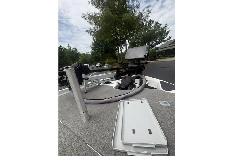 Slide: The Image of 2012 Bass Cat Cougar FTD boat deck with equipment and open storage compartment. - 16