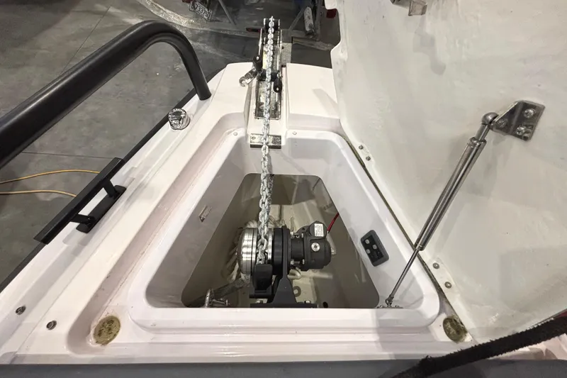 Slide: The Image of Anchor compartment of 2021 Axopar 28 Cabin boat, featuring chain and winch system. - 22