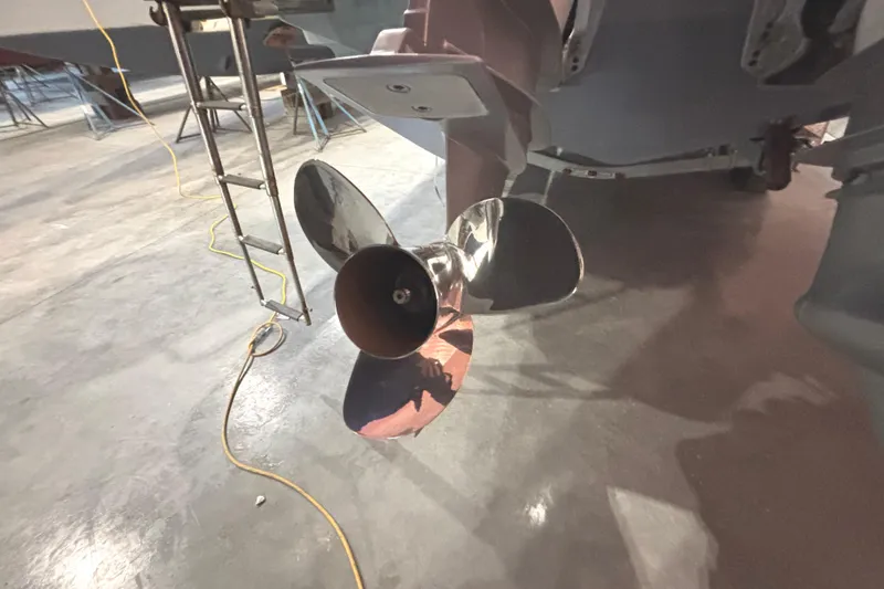 Slide: The Image of Propeller of a 2021 Axopar 28 Cabin boat in a workshop setting. - 28