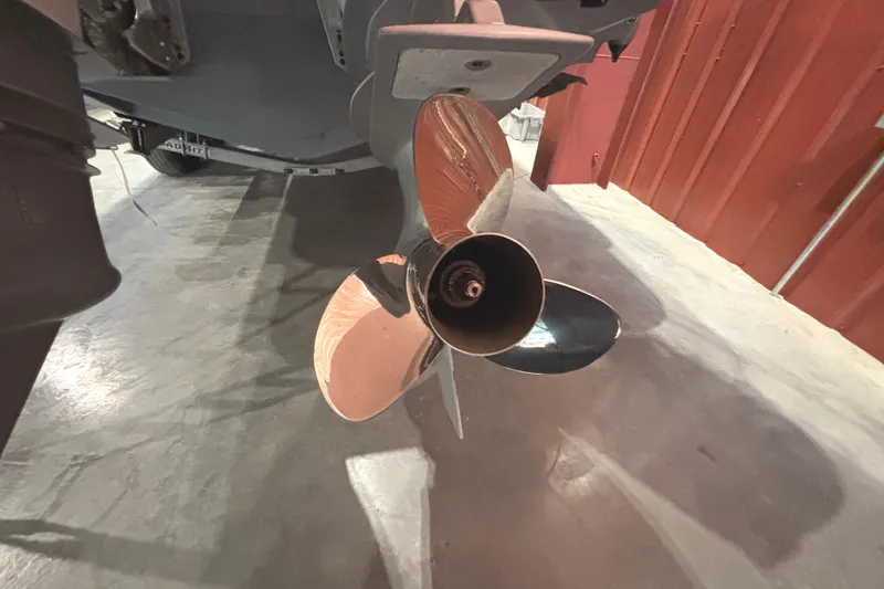 Slide: The Image of Close-up of a 2021 Axopar 28 Cabin boat propeller in a garage setting. - 27