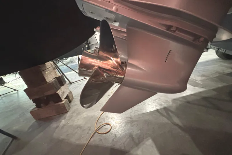 Slide: The Image of Close-up of a 2021 Axopar 28 Cabin boat propeller in a workshop setting. - 26