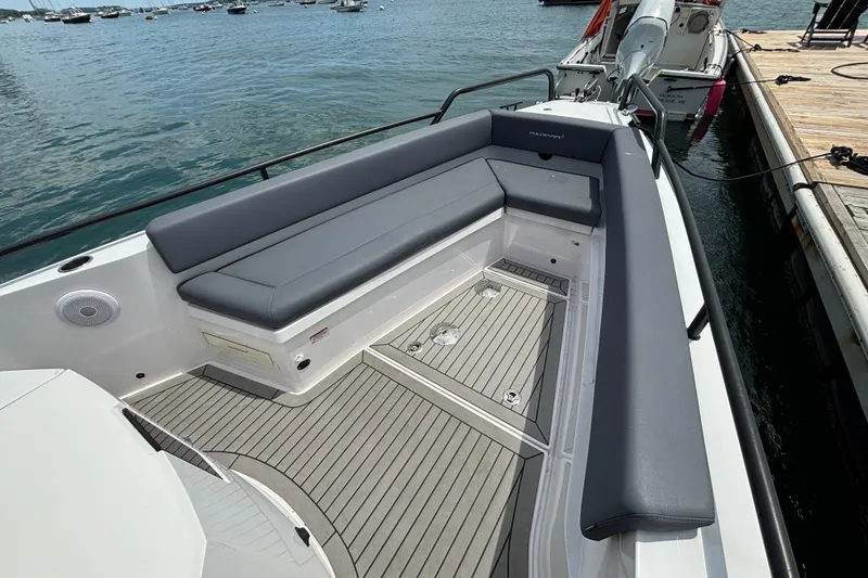 Slide: The Image of 2021 Axopar 28 Cabin boat with spacious seating and sleek design by the dock. - 10